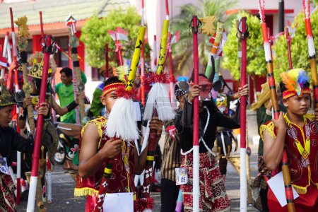 Photo for Stilts (festival egrang) carnival to celebrate Indonesian independence day at simpang lima gumul kediri - Royalty Free Image