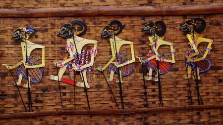 Photo for The indonesian puppets which called wayang (Javanese puppet) on white background. Wayang are made of goat, cow or buffalo skin - Royalty Free Image