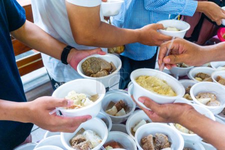 Sharing food on Kirab ketupat. Kirab ketupat is a celebration of Eid al-Fitr by distributing free food
