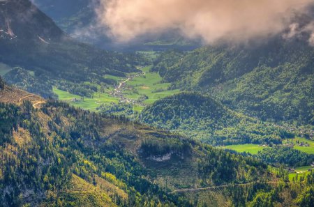 Photo for Road in Austrian mountains. Road winding above the valley and village, view from Loser peak in Dead Mountains (Totes Gebirge) in Austria. - Royalty Free Image