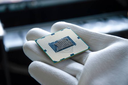Photo for An image of a technician holding a CPU in his hand. - Royalty Free Image