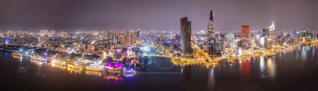 Aerial panoramic cityscape view of HoChiMinh city and the River Saigon, Vietnam with blue sky at sunset. Financial and business centers in developed Vietnam.
