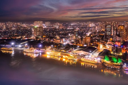 Aerial panoramic cityscape view of HoChiMinh city and the River Saigon, Vietnam with blue sky at sunset. Financial and business centers in developed Vietnam.