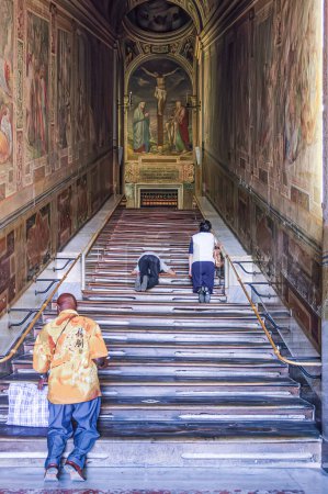 Photo for Rome, Italy, August 23, 2008: Faithful kneeling up the Scala Santa to access the Sancta Sanctorum. - Royalty Free Image