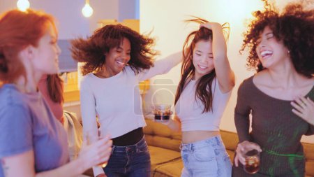 Photo for View of multi-ethnic women dancing happily in a night party at home - Royalty Free Image