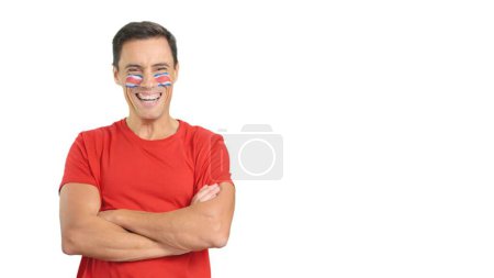 Man standing with costa rican flag painted on face smiling with arms crossed
