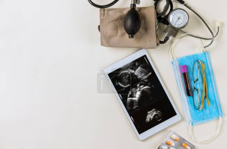 Photo for Doctor checks ultrasound of during pregnancy woman to prescribe treatment preserve baby in medical office - Royalty Free Image