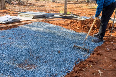 Photo for Creating level surface for gravel as deck foundation the shed in backyard. - Royalty Free Image