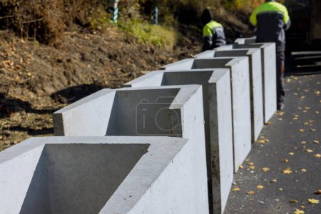 Photo for In order to water drain reconstruction road, precast concrete u-shaped drains were installed along road - Royalty Free Image