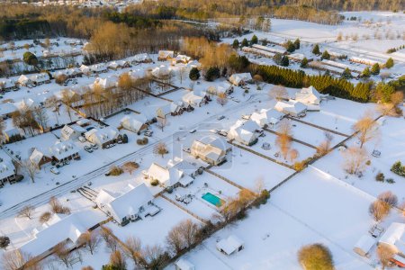 An aerial view of small American town after winter storm with beautiful snowy landscape in South Carolina United States.