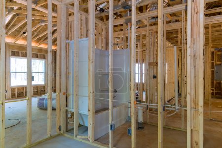 Photo for When newly constructed house is completed with framing beams, wood sticks plumbing it imperative that they are all completed before plasterboard - Royalty Free Image