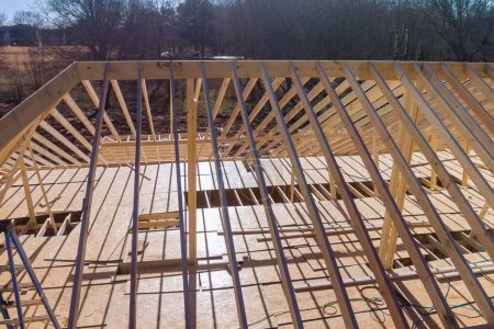 Photo for Wooden roofing framework consists of trusses beams were built while beam stick support roof to constructing new home. - Royalty Free Image