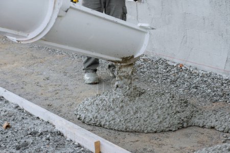 Photo for Pouring of concrete was mixing concrete was done by machine for uniform consistency. - Royalty Free Image