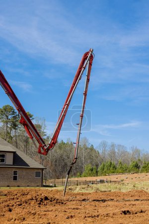 Photo for Prepare for building foundations is pouring cement concrete directing an automatic pump - Royalty Free Image