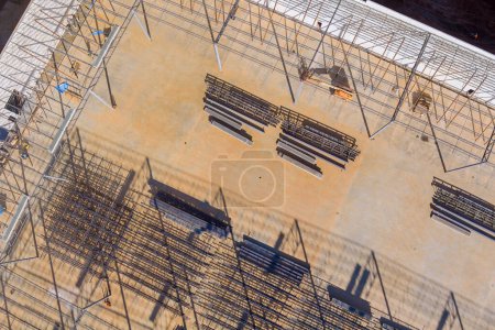 Photo for Construction of metal trusses frame for steel warehouse work on construction site - Royalty Free Image