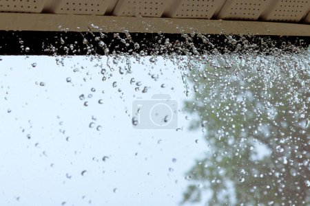 When it rains heavily, water pours out of over gutters.