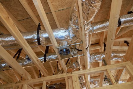Photo for Installation of central conditioning HVAC system highlights wooden beamed ceiling in new home. - Royalty Free Image