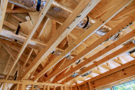Photo for Wooden beamed ceiling in new home gains prominence with installation of central HVAC system. - Royalty Free Image