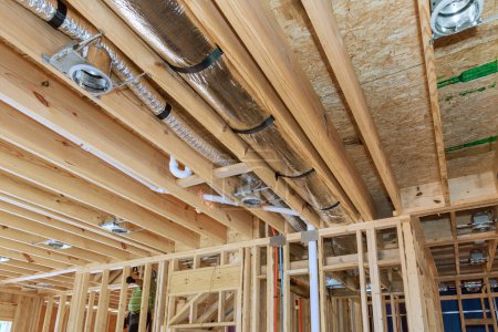Photo for Installing central HVAC system puts spotlight on wooden beamed ceiling in new home. - Royalty Free Image