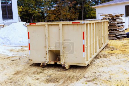 Photo for Loaded dumpster for construction waste debris near construction site - Royalty Free Image