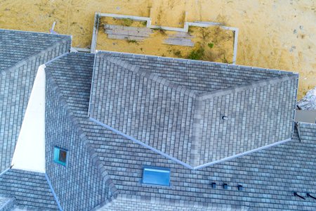 Photo for When constructing newly built house roof is being covered with asphalt shingles as built home place - Royalty Free Image