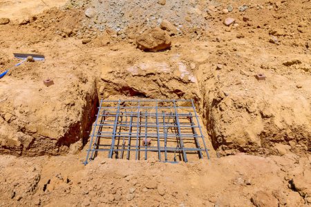 Photo for Pouring concrete foundation in trench prepared for cottage concrete deep strip foundation - Royalty Free Image