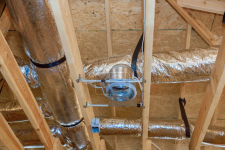 Photo for HVAC conditioning ventilation system is installed, as well as metal duct pipeline, for new residence home - Royalty Free Image