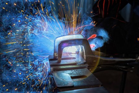 Photo for During welding using argon gas, sparks created by welding process produce smoke in factory - Royalty Free Image