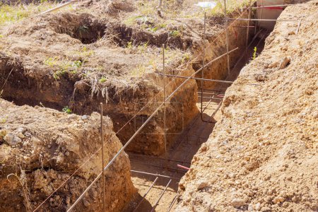 Photo for Foundations are being prepared for concrete pouring by digging trenches - Royalty Free Image