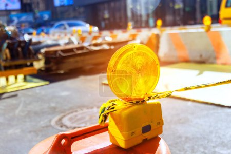 Photo for Construction warning lights are displayed on barricade in road that is undergoing reconstruction - Royalty Free Image