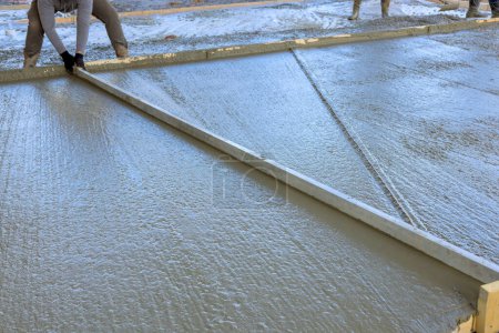 Photo for Concrete has been poured for driveway at new house with wet cement - Royalty Free Image