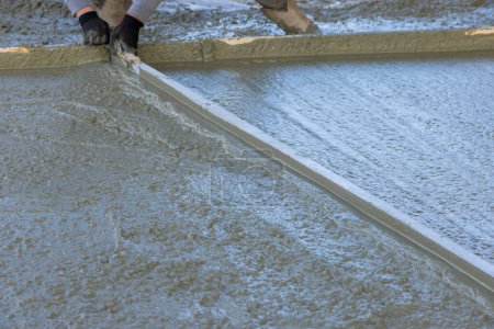 Photo for Concrete driveway for new house has been poured using wet cement - Royalty Free Image