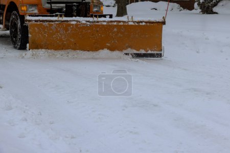 In residential area following heavy snowstorm, snowplow trucks remove snow from roads