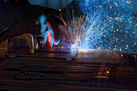 Photo for Workers welding steel using argon gas generate sparks that smoke during work in factory - Royalty Free Image