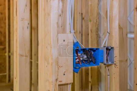 Photo for Electrical switch box is plastic wires attached to its wooden frame beams - Royalty Free Image