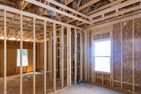 Photo for New home unfinished construction with support beams stick trusses framing - Royalty Free Image