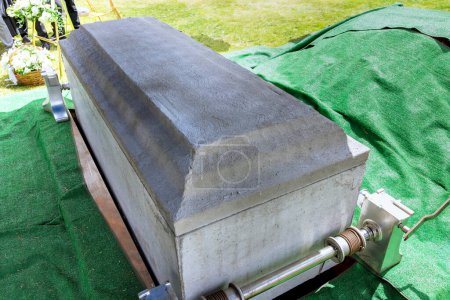 Funeral service with coffin of deceased during ceremony