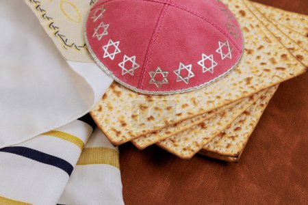 Traditionally, Jews celebrate Passover by eating unleavened matzah bread a wearing kippahs tallits