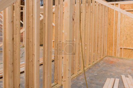 Construction of new home involves use of stick beams, wood, framing