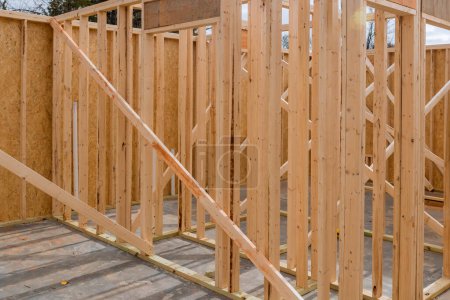 When constructing new home, wooden stick beams used in framing process