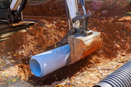 Photo for Laying pipes to feed rainwater into water main collector at construction site - Royalty Free Image