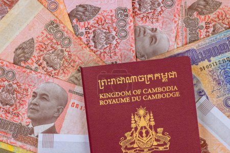 Kingdom of Cambodia Passport over Cambodian different nominal national currency Riels banknotes