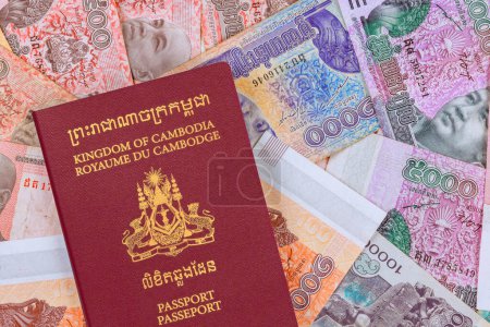 Passport of Kingdom of Cambodia over various nominal currencies banknotes in Cambodian Riels