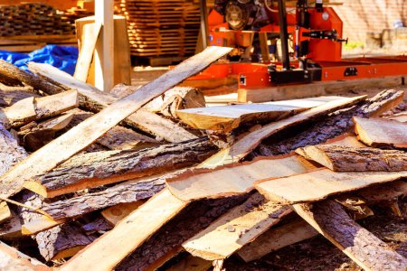 After sawing, wood scrap debris is stacked near sawmill