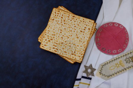 Unleavened matzah bread of Passover is symbol of celebration along with kippahs tallit