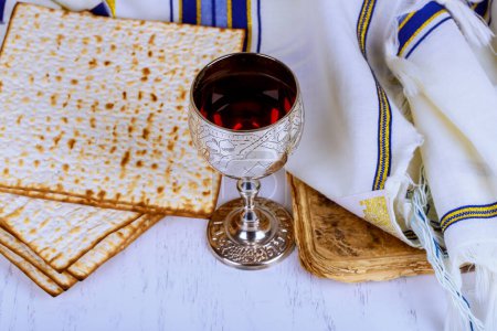 Photo for Commemorating passover with jewish pesach attributes, kosher wine, matzah flatbread bread - Royalty Free Image