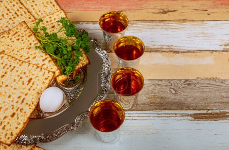 During Pesach, families gather to commemorate liberation of Israelites with red kosher wine unleavened bread matzo
