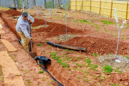 Installing an underground drainage system for outflow of rain stormwater