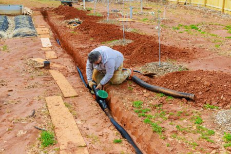 Laying underground drainage pipes to drain rainwater a stormwater