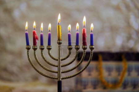 In Jewish religion, holiday symbol for Hanukkah is Hanukkiah menorah with candles burning.
